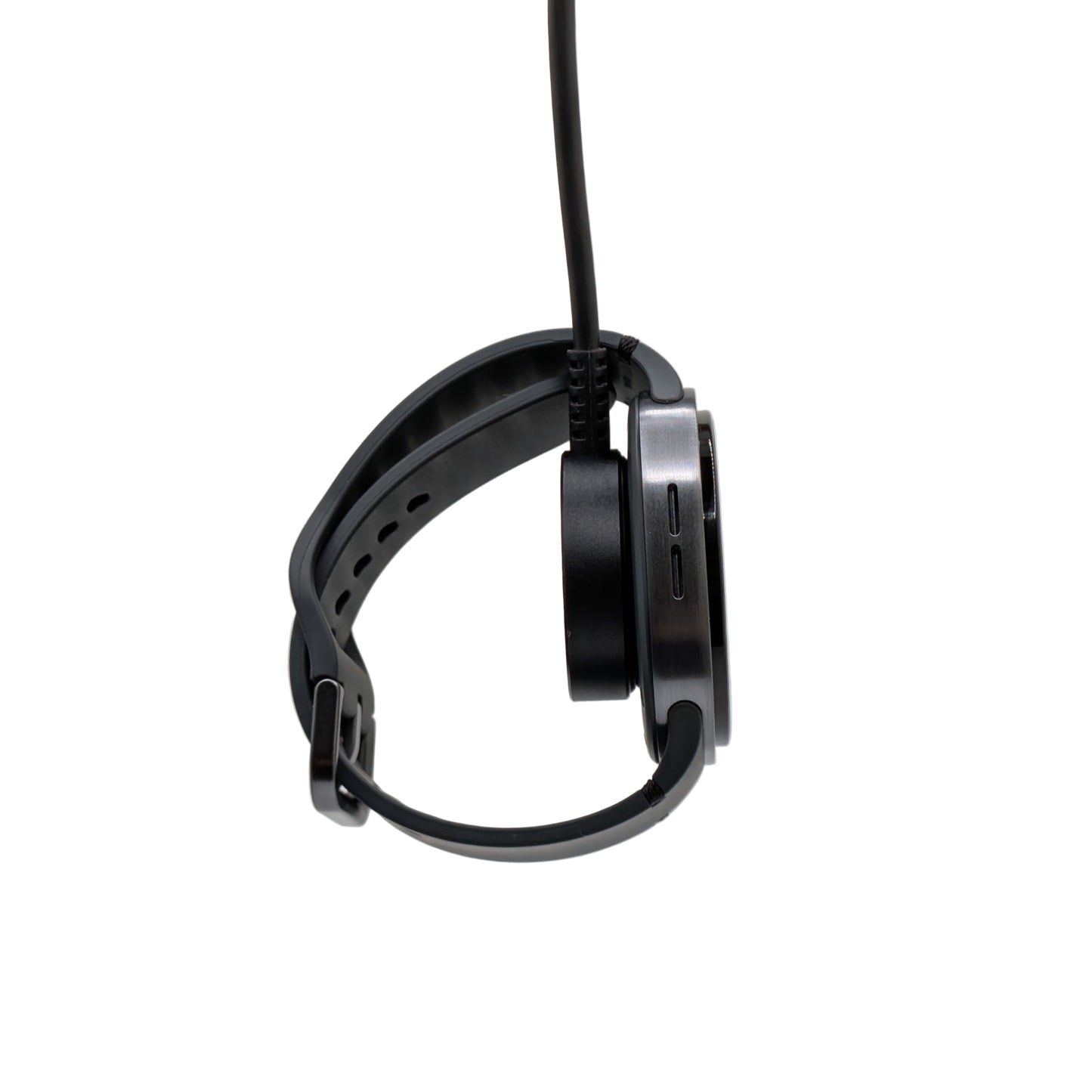 Watch dangling from a charging puck on a white background