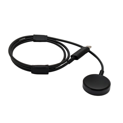 Black electronic charging puck with cable on a white background